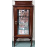 A late Victorian mahogany and satinwood inlaid peer cabinet with glazed door concealing mirrored