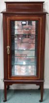 A late Victorian mahogany and satinwood inlaid peer cabinet with glazed door concealing mirrored