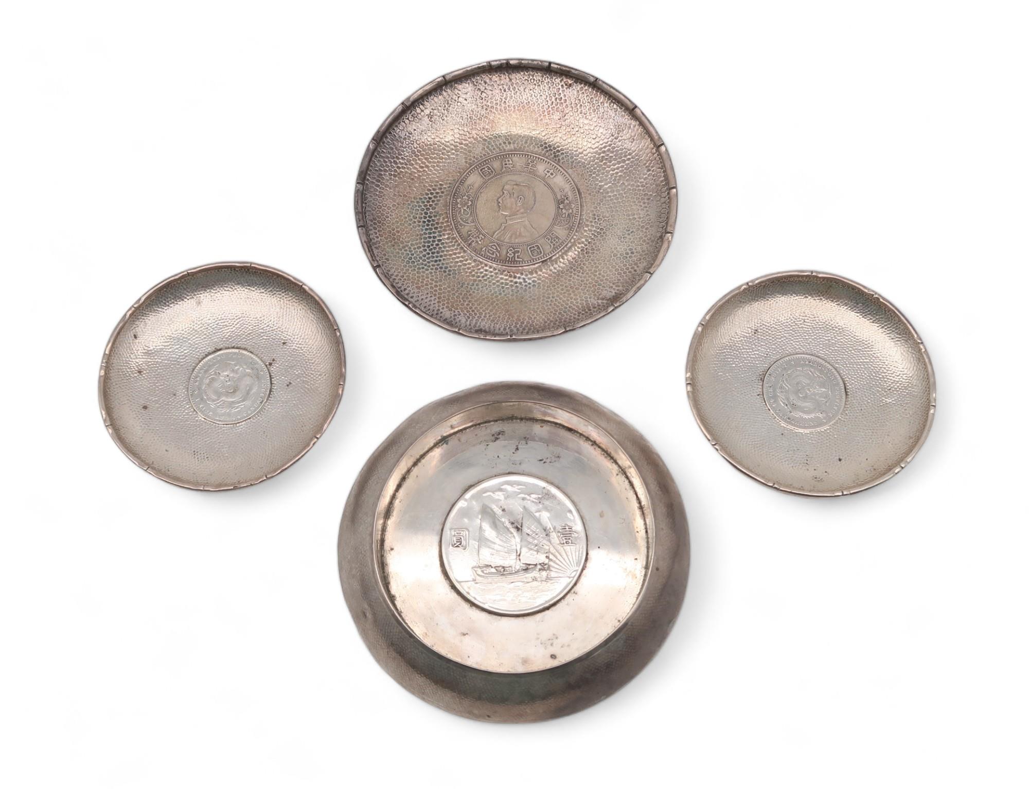 A collection of Chinese silver coin dishes, one inset with a Republic of China One Dollar, two Pei