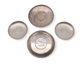 A collection of Chinese silver coin dishes, one inset with a Republic of China One Dollar, two Pei