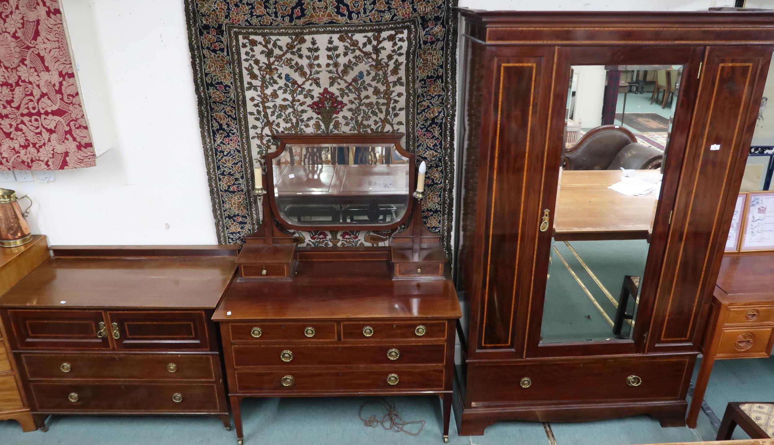 An Edwardian mahogany bedroom suite comprising mirror doored wardrobe, 210cm high x 131cm wide x