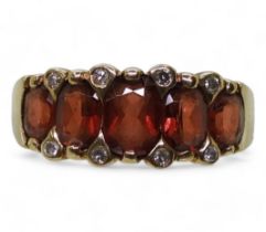 A 9ct gold garnet and diamond accent ring, size O1/2, weight 3.2gms Condition Report:Available