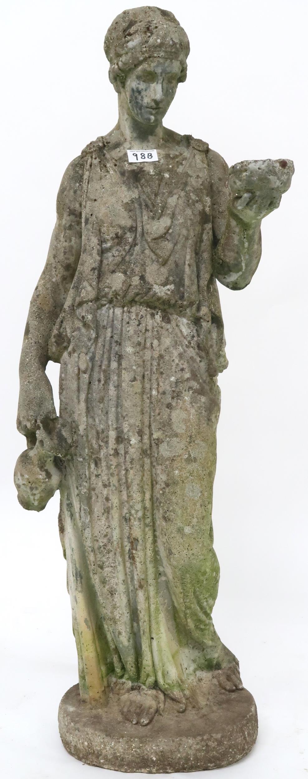 A 20th century reconstituted stone garden statue of a classical lady in toga carrying jug and