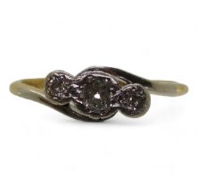 An 18ct gold and platinum three stone diamond ring set with estimated approx 0.15cts of brilliant