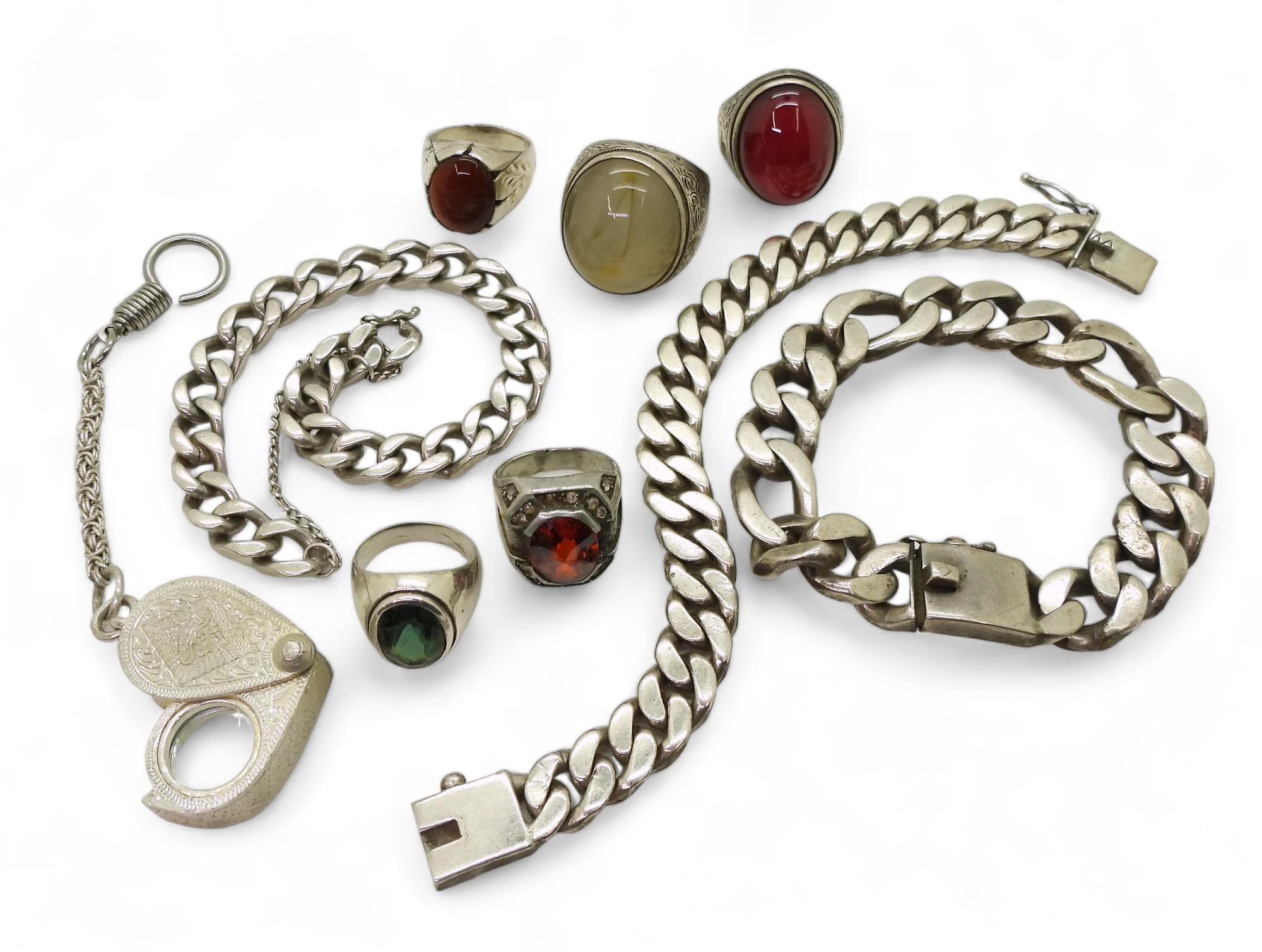 Three white metal curb chain bracelets two stamped 925, a collection of white metal rings and a