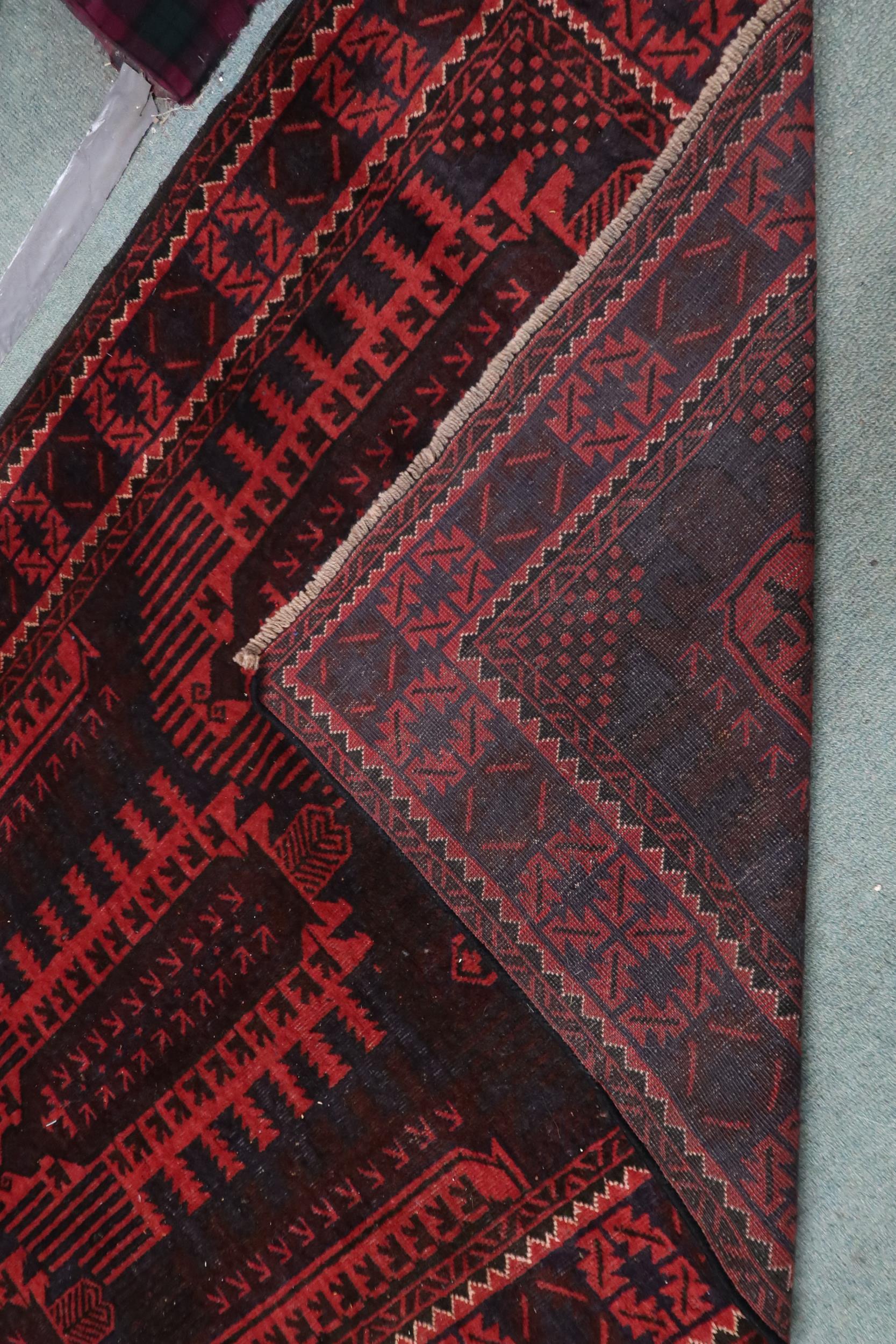 A dark red ground Afghan Bellucci tribal rug with geometric patterned ground within geometric - Image 3 of 3