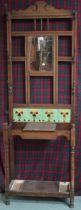 A late Victorian oak hall stand with bevelled glass mirror over tiled splash back and paired