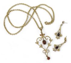 A 9ct gold Edwardian style garnet and diamond pendant on a 50cm, 9ct gold belcher chain together