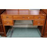 A contemporary Oriental hardwood writing desk with long central drawer flanked by two short