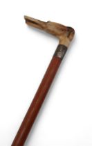 A silver collared riding crop, by H & S, London 1943, the handle carved in the form of a hound,