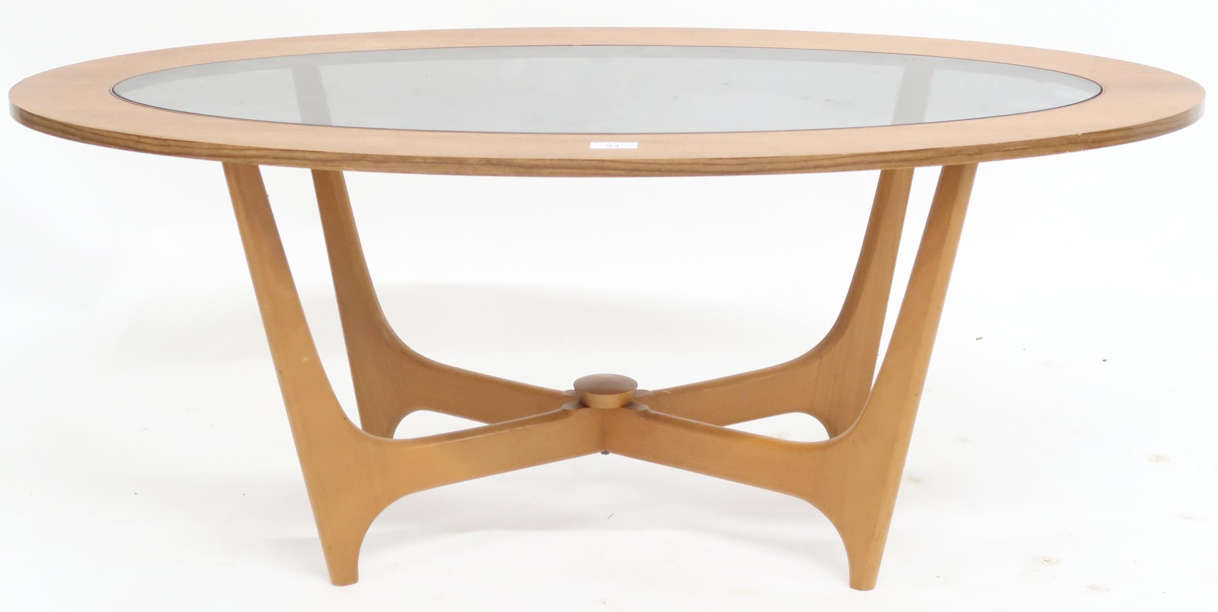 A mid 20th century teak G Plan Astro style coffee table with glass inset top on crossed supports,