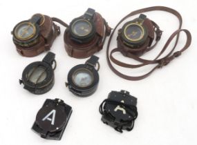 Seven assorted military compasses, comprising a leather-cased example by F. Barker & Son, London,