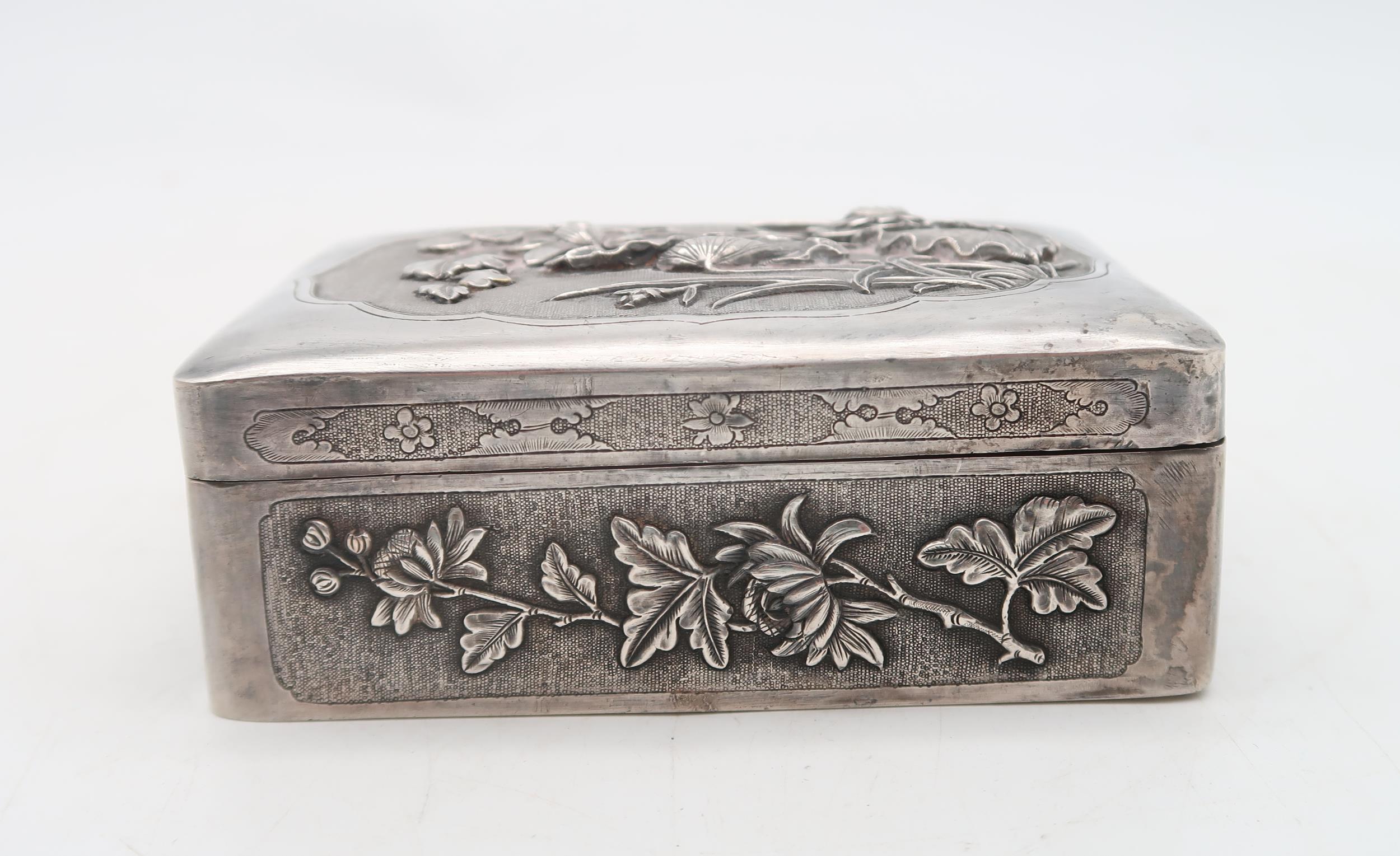 A Chinese white metal box, embossed with floral decoration, marked to the interior, 11 x 8.5cm - Image 2 of 3