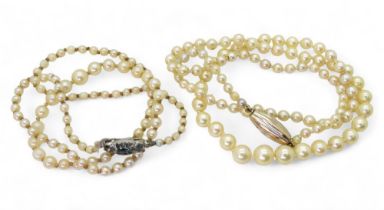 Two strings of cultured pearls, one with a bi colour clasp, length 53cm Condition Report:The
