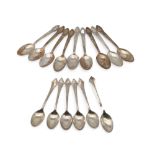 A set of eight marked 'Silver' tea spoons, with scrolling foliate terminals, and another set of