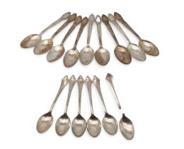 A set of eight marked 'Silver' tea spoons, with scrolling foliate terminals, and another set of