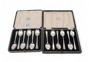 A set of cased silver teaspoons, by James Deakin & Sons, Sheffield, and another by Elkinton & Co,