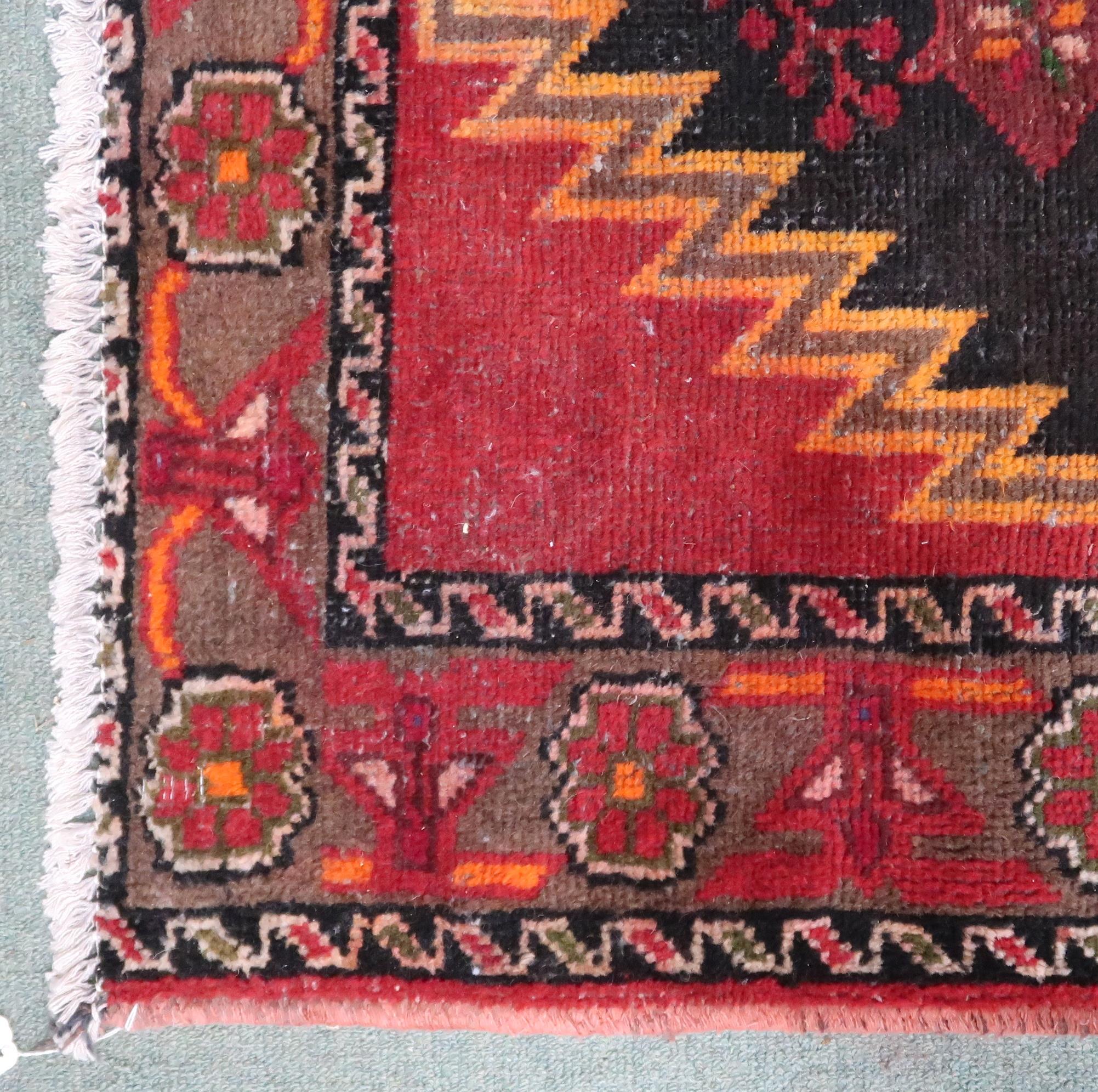 A red and black geometric ground Persian Village rug with geometric floral/foliate design with - Image 2 of 3