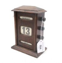 An early-20th century stained oak perpetual desk calendar, measuring approx. 16.5cm in height