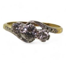 An 18ct gold and platinum three stone diamond ring set with estimated approx 0.30cts of brilliant