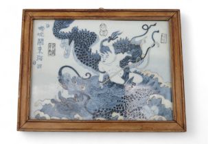 A blue and white porcelain plaque, depicting Nezha battling the East Sea Dragon, a celadon ground