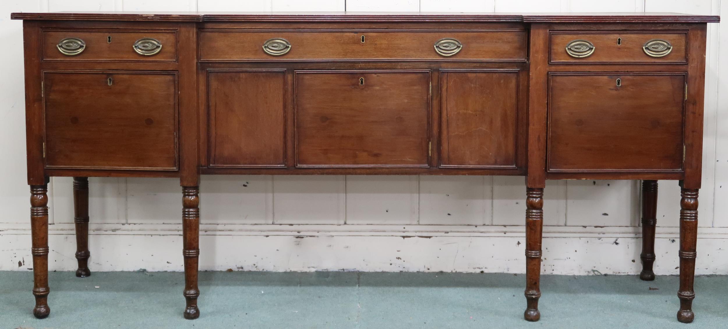 A late Victorian mahogany inverted breakfront sideboard with three drawers over three cabinet