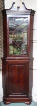 An early 20th century mahogany astragal glazed corner cabinet with scrolled surmount over astragal