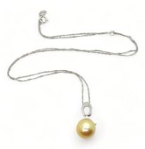 An 18ct white gold golden South sea pearl pendant further set with diamond accents and on a 18ct