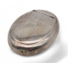 A Victorian silver tobacco box, by George Unite, Birmingham 1882, of oval form, monogrammed,