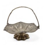 An EPNS swing-handled cake basket, of lobed form, with embossed scrolling foliate decoration