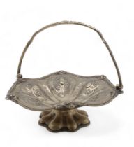 An EPNS swing-handled cake basket, of lobed form, with embossed scrolling foliate decoration