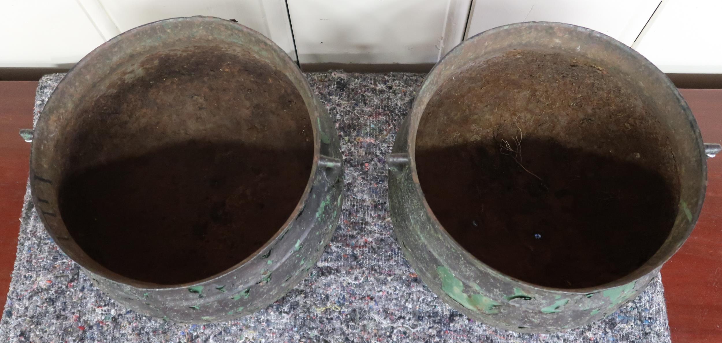 A pair of 19th century cast iron cauldrons with twinned handles on three feet, 27cm high x 36cm - Image 2 of 4