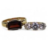 A 9ct gold cubic zirconia three stone ring, size P1/2, together with a garnet ring, size P1/2,