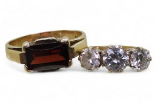 A 9ct gold cubic zirconia three stone ring, size P1/2, together with a garnet ring, size P1/2,