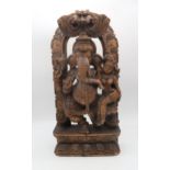 A carved wooden sculpture of Ganesh with a consort, 60cm high Condition Report:Available upon