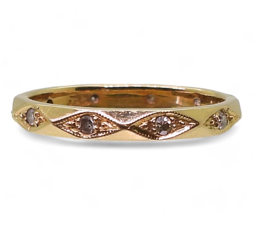 An 18ct gold full diamond eternity ring of facet pattern, size M1/2, weight 2.6gms Condition
