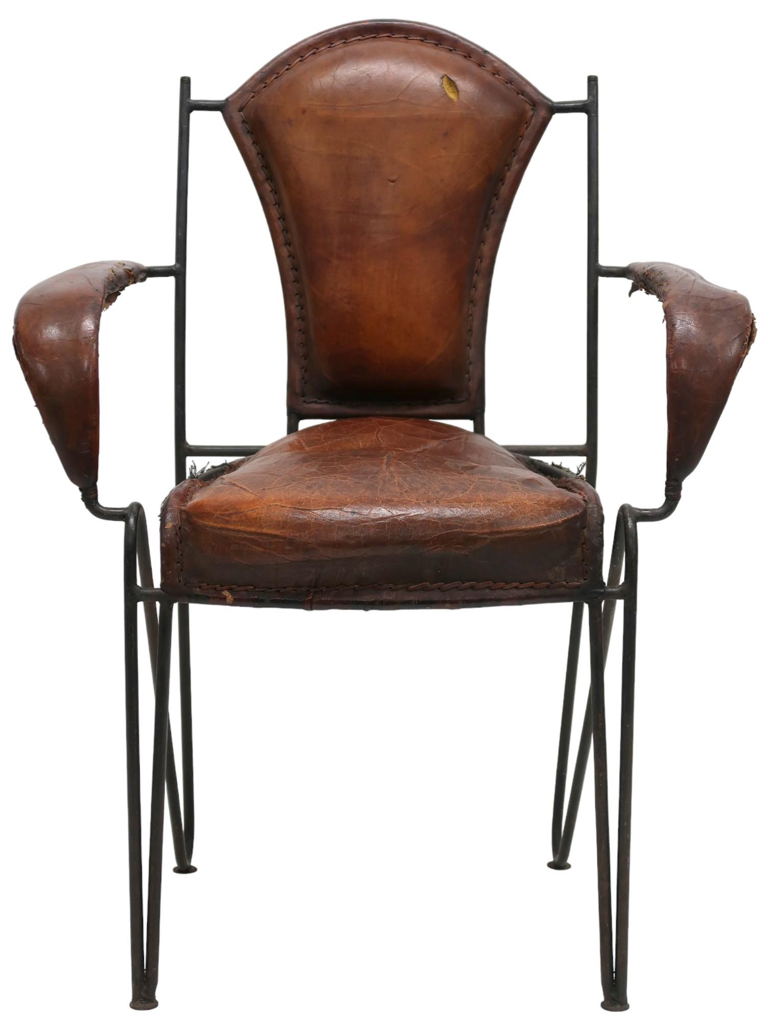 A MID 20TH CENTURY LEATHER & IRON ARMCHAIR AFTER JACQUES ADNET with open armrests made with stitched