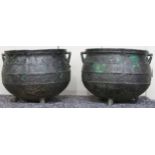A pair of 19th century cast iron cauldrons with twinned handles on three feet, 27cm high x 36cm