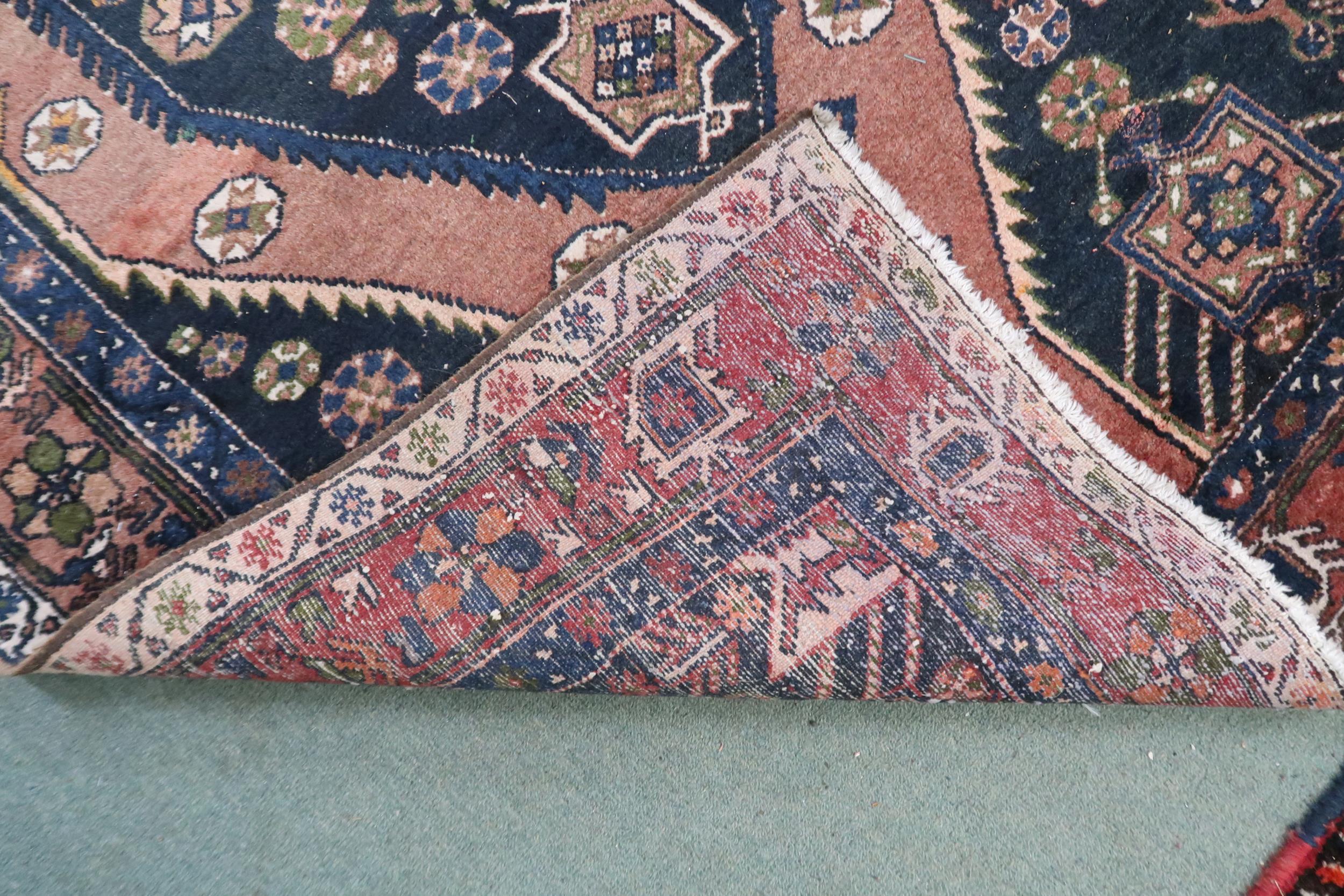 A pink ground balouchi rug with blue diamond central medallion, matching spandrels and pink - Image 3 of 3