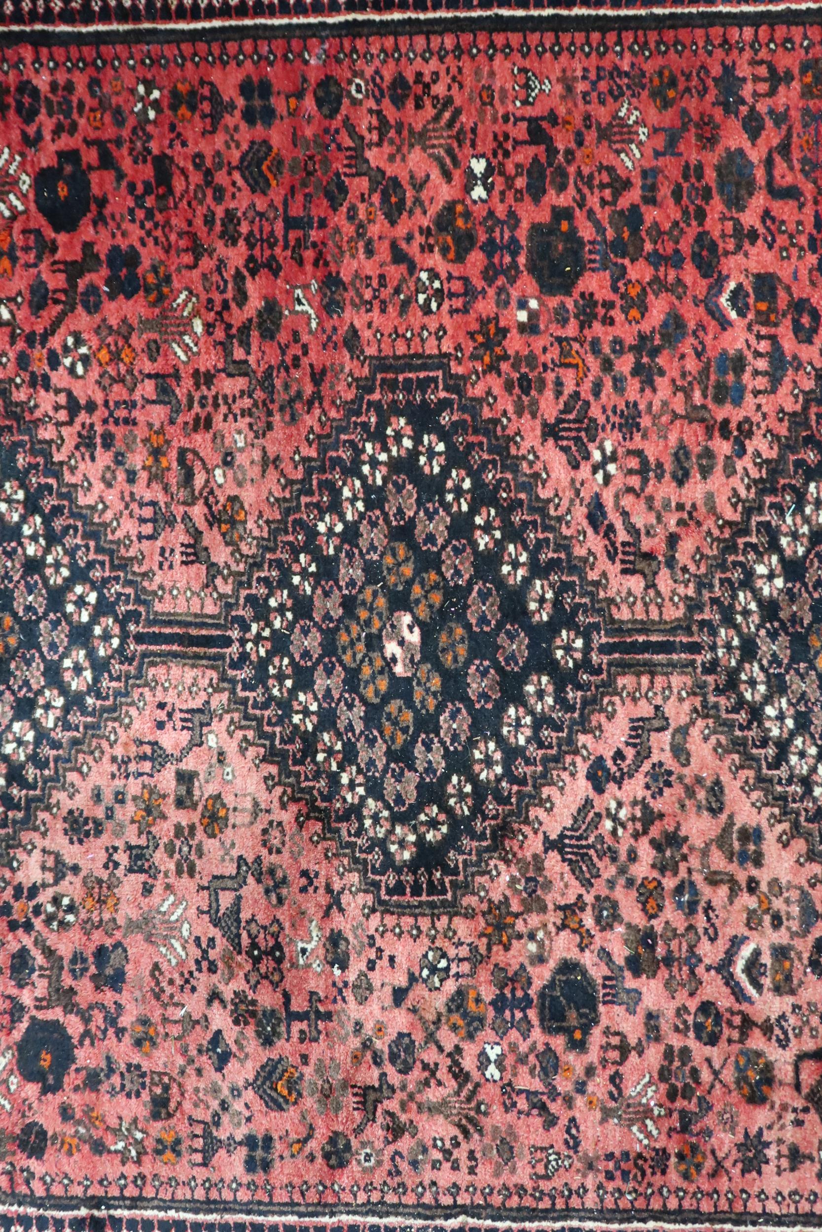 A red ground Hamadan rug with three diamond form medallions and dark blue spandrels within - Image 4 of 4