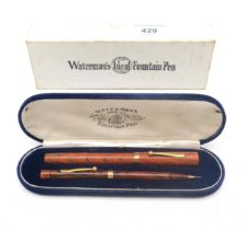 A Waterman's Ideal fountain pen and propelling pencil set, of "Ripple" design, with 9ct gold mounts,