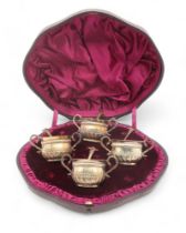 A cased set of four Victorian silver gilt salts, by Wakeley & Wheeler, London 1883, the spoons 1885,