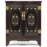 A 20th century Chinese hardwood two door side cabinet with lacquered panel top, sides and doors