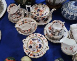 An early 19th century imari pattern teaset comprising teapot, cups, saucers, jug, sugar pot, bowl