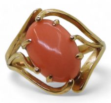 A yellow metal ring set with a coral, size Q, weight 3.8gms Condition Report:Available upon request