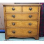 A 20th century oak two over three chest of drawers with stylized drawer pulls, 98cm high x 99cm wide