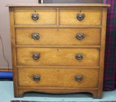 A 20th century oak two over three chest of drawers with stylized drawer pulls, 98cm high x 99cm wide