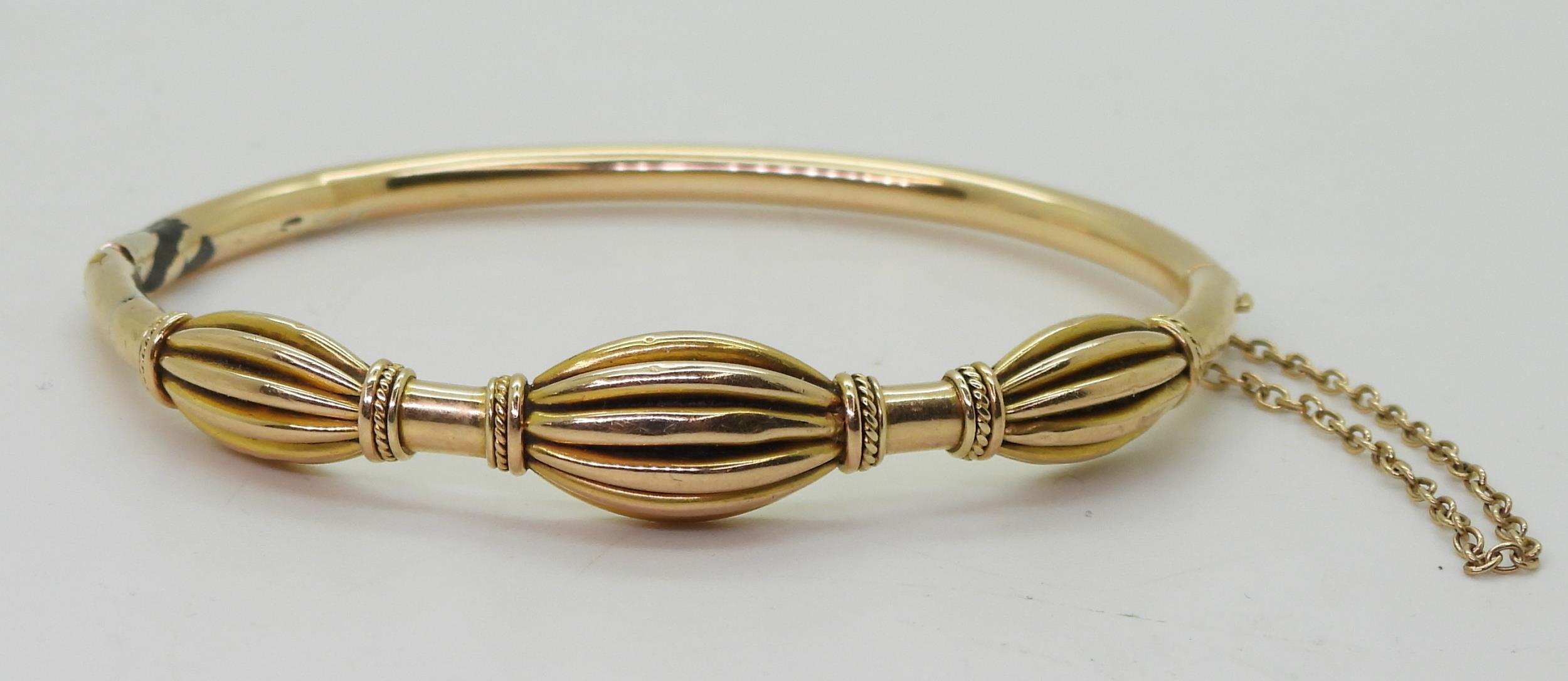 A yellow metal bangle, with oval pleated bead design (af) diameter 6.2cm, weight 12gms Condition - Image 3 of 4