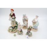 A collection of European figures including a Derby figure of a lady with a lamb at her feet etc