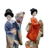 Two Japanese geisha dolls, one holding a parasol, the other a branch, 43 and 45cm high Condition